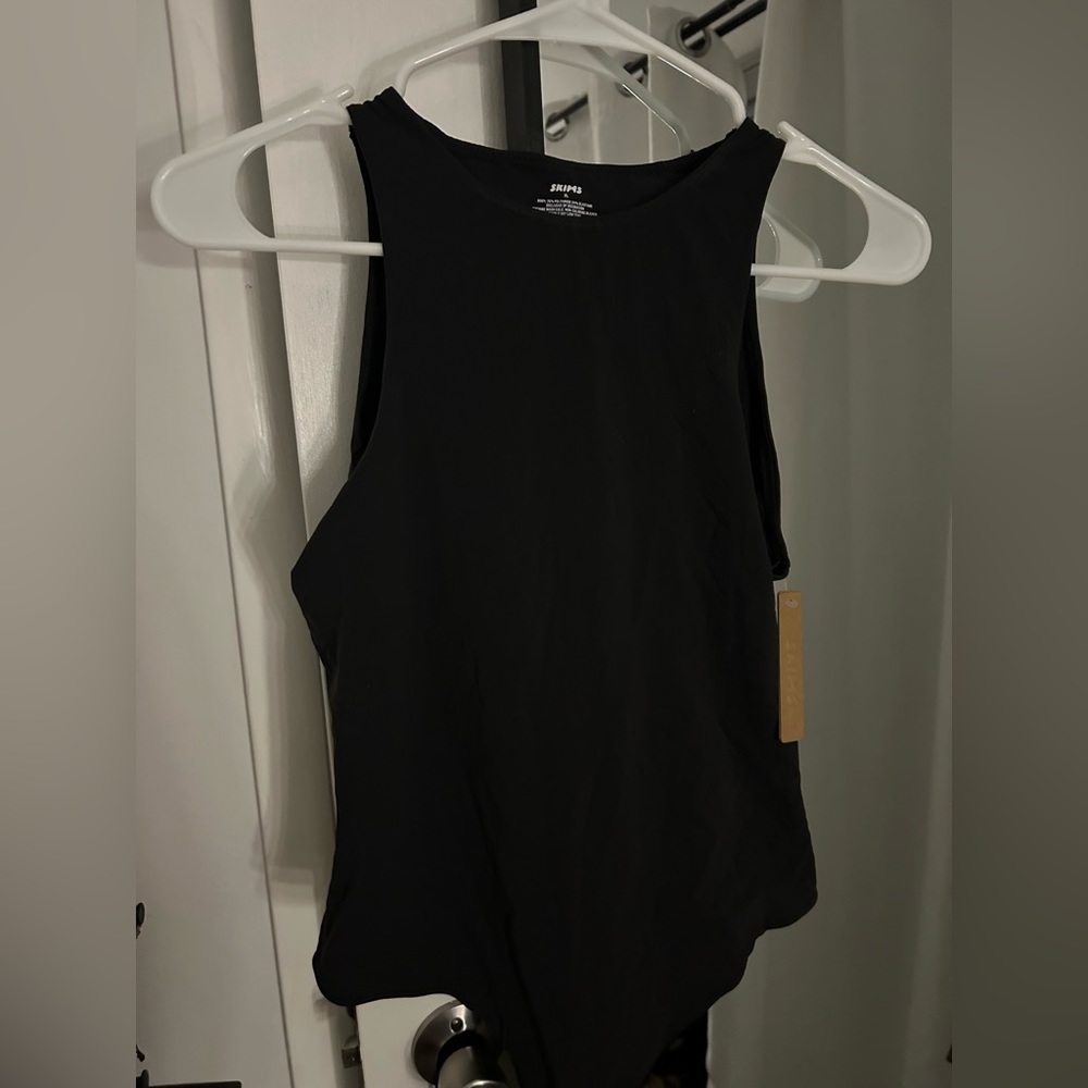 *Never Worn, Tags On* Sleeveless “Fits everyone” SKIMS body suit in color ONYX